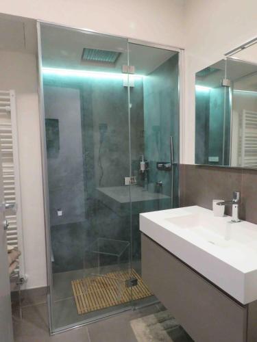 a bathroom with a glass shower and a sink at Les fleuves - Buthier in Aosta