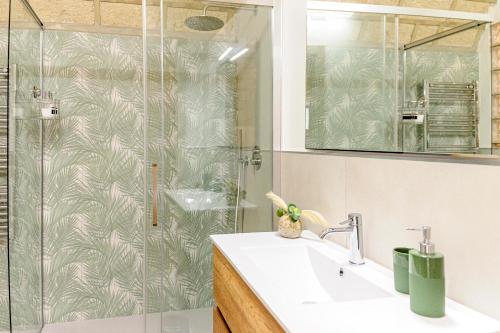 a bathroom with a sink and a glass shower at Villa Franca in Bari