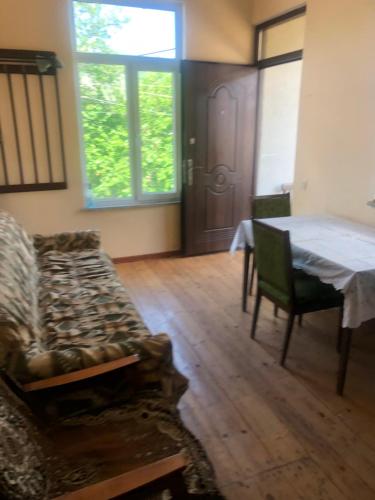 a living room with a couch and a table at L&A Guest House in Goris