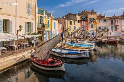 a group of boats docked in a canal with buildings at VERDON GRAN VALA 2 les pieds dans l'eau in Martigues