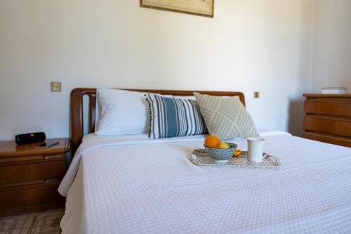a bed with a tray with a bowl of fruit on it at Traditional 3 bedroom house in the Old Town in Rhodes Town