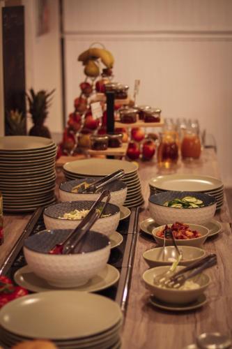 a table topped with plates and bowls of food at Centrooms Eger in Eger