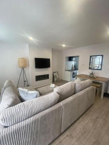 a living room with a couch and a table at Quay Cottage in Parkgate