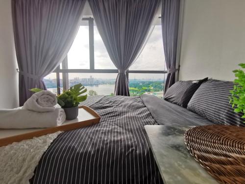 a bedroom with a bed and a large window at 3 Astetica Residences The Mines 4BR WiFi Netflix Lake View in Seri Kembangan