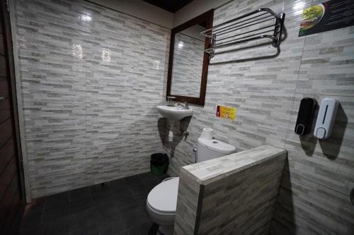 a bathroom with a toilet and a sink at Adil Villa & Resort in Ubud
