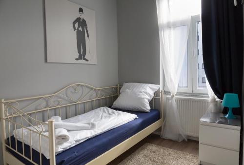 a small bedroom with a bed and a window at Hotel Forty Four in Frankfurt