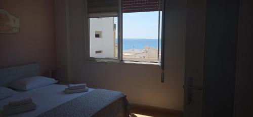 a bedroom with a window with a view of the ocean at B&B Centrale in Gallipoli