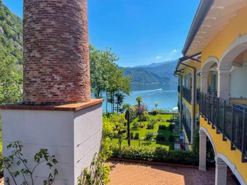 a balcony of a house with a view of the water at Yachting Residence in Lavena Ponte Tresa