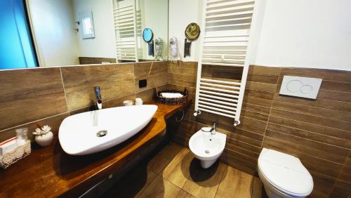 a bathroom with a sink and a toilet at Attico Barocco in Lecce