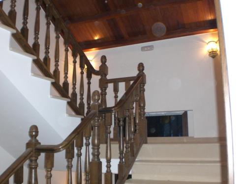 a staircase with wooden railings in a house at Casa Buda Conors & Spa in Foz