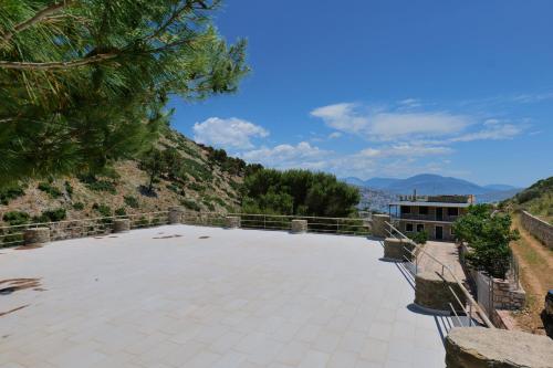 a large patio with a view of the mountains at Green Villa in Sarandë