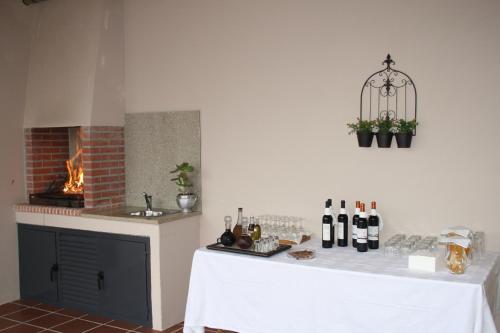 a kitchen with a table with wine bottles on it at Casa de l Puio in Picote