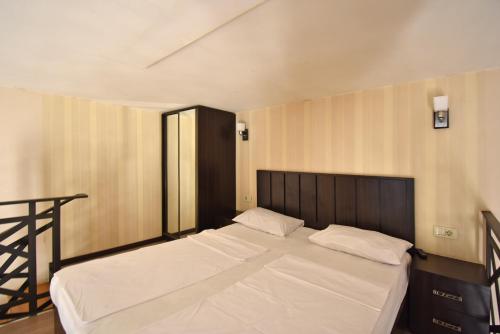 a bedroom with a large bed with white sheets at Apartment Koryun 1 in Yerevan