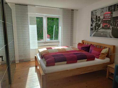 a bedroom with a bed with a plaid blanket at Nähe Spieleland in Vogt