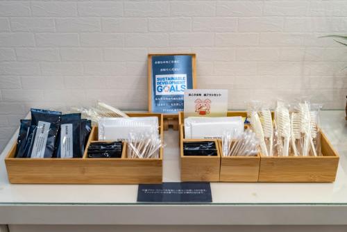 two wooden trays filled with books on a table at ETAVIA Yufuin Kinrinko in Yufuin