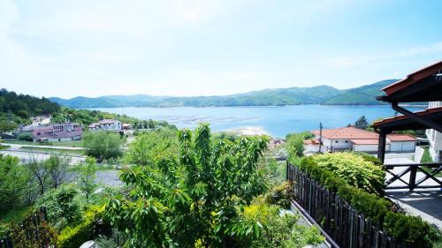 a view of a lake from a house at Penev guest house in Glavatartsi