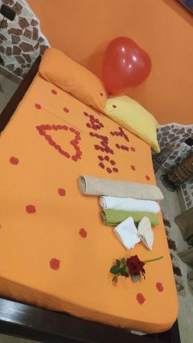 a birthday cake with a knife and hearts on it at B&B L'Altro Anfiteatro Camera suite in Santa Maria Capua Vetere