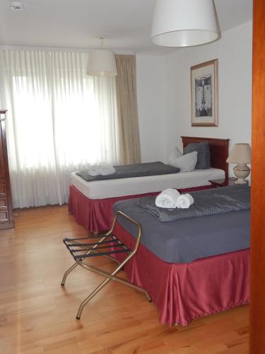 a hotel room with two beds and a chair at FREE Apartment - Obere Wässere in Reutlingen