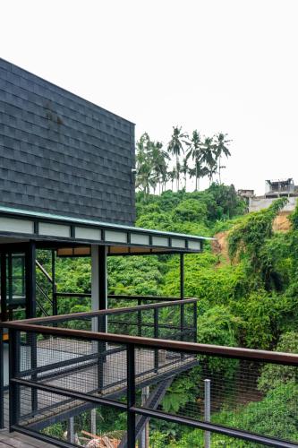 a building with a walkway next to a hill at Zenubud in Ubud