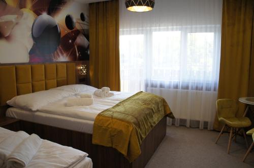a hotel room with a bed and a window at Hotel Biele Studničky Dargov in Dargov