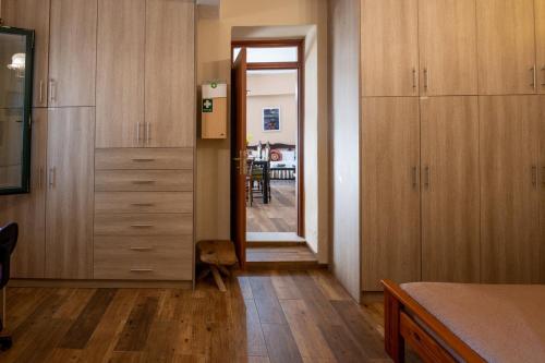a kitchen with wooden cabinets and a door leading to a dining room at Villa Roxani in Mesklá