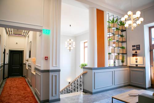 a lobby with a hallway with a stair case at House Of Charles in Carei