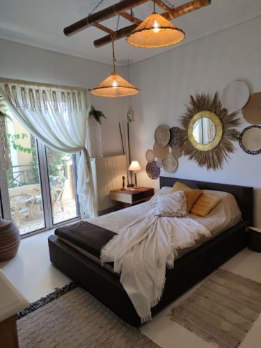 a bedroom with a large bed and a mirror at KD Boho Home in Lávrion