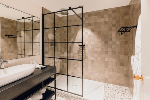a bathroom with a shower and a sink at Cèdre Beaune, A Beauvallon Hotel & Spa in Beaune