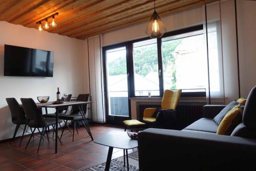 a living room with a couch and a table with chairs at Fewo Lehner in Riedenburg