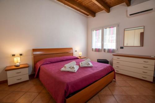 a bedroom with a bed with two towels on it at GaLi eco-apartment in Olbia