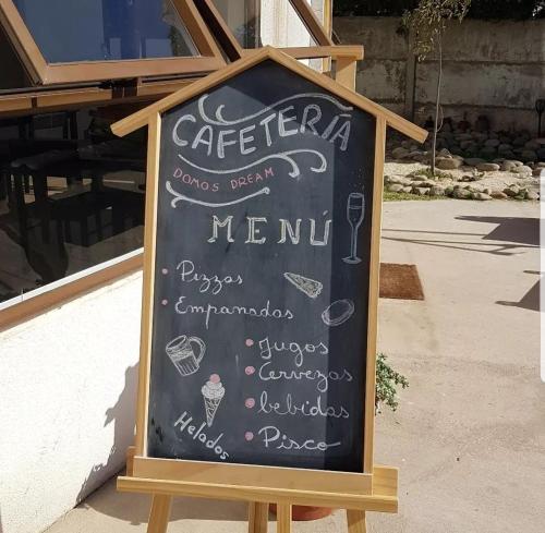 a chalkboard sign in front of a restaurant at Domos Dream in La Serena