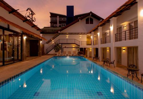 a swimming pool in the middle of a house at The Nest Resort Patong in Patong Beach