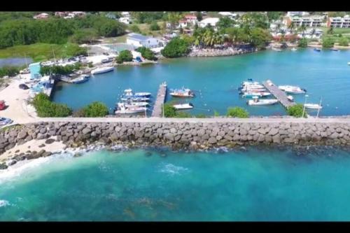 an aerial view of a marina with boats in the water at Paradise Duplex avec piscine et accés Plage in Le Gosier