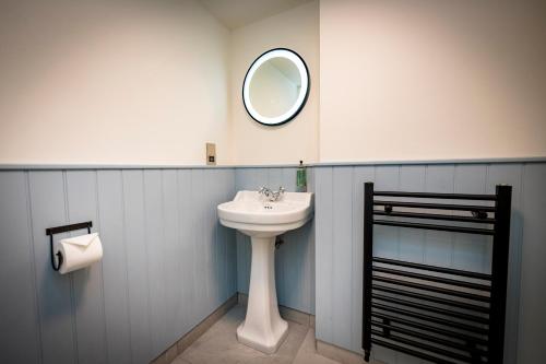a bathroom with a sink and a mirror on the wall at Loch Ness Inn in Drumnadrochit