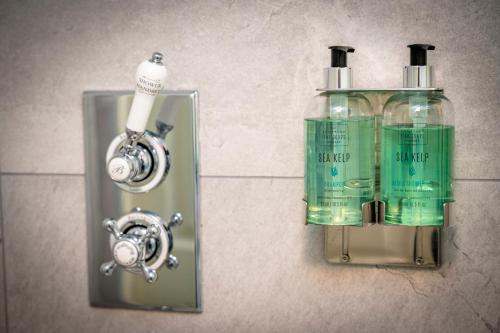 two bottles of soap are attached to a wall at Loch Ness Inn in Drumnadrochit