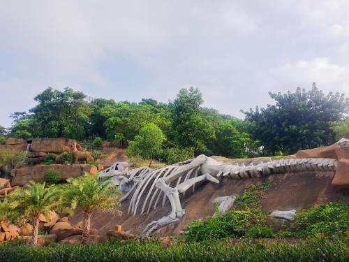 a skeleton of a dinosaur in a garden at Sunrise Motel in Ha Long