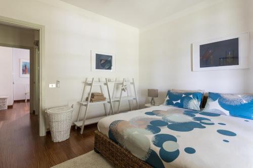a bedroom with a large bed with blue pillows at Villa Cuore by Garda FeWo in Salò