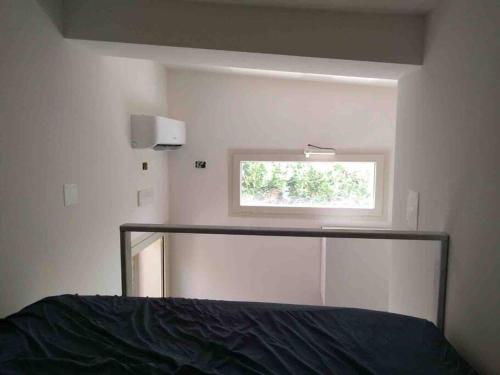 Schlafzimmer mit einem Bett und einem Fenster in der Unterkunft Casa vacanze nuova con ampio giardino attrezzato in San Domino