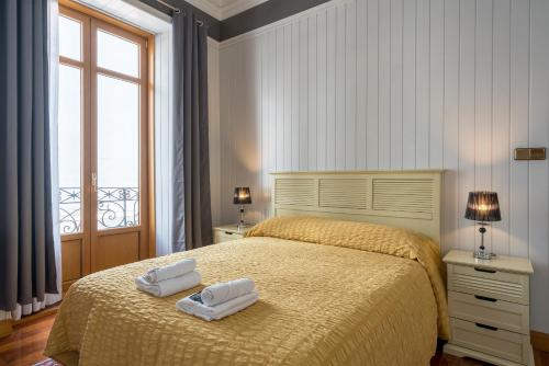 a bedroom with a bed with two towels on it at Ayala apartment by People Rentals in Bilbao