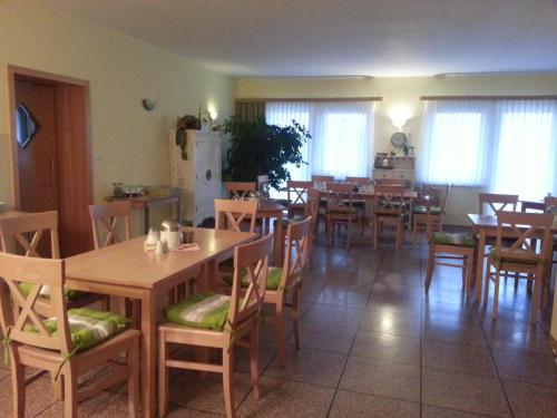 a dining room with wooden tables and chairs at Hotel zum Jahnatal in Ostrau