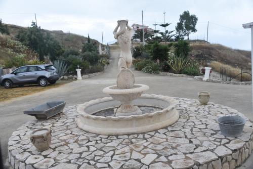 a fountain in the middle of a parking lot at La valle degli dei in Eraclea Minoa