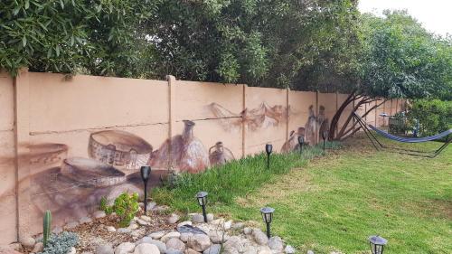 a wall with a painting of people on it at Domos Dream in La Serena