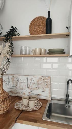 a kitchen with two cups on a tray on a counter at NOMAD SURF HOUSE in Corralejo
