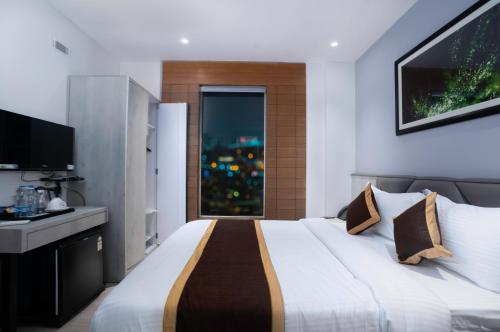 a bedroom with a large bed and a window at Poiisse in Kolkata