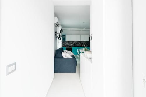 an open door to a living room with a blue couch at Le Isole di Anita in Lipari