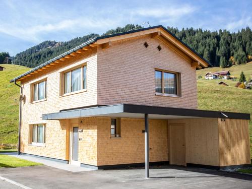 a large brick house with a garage at Chalet Alpenluft in Hirschegg