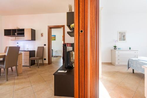 a living room with a kitchen and a dining room at Residence La Corte Di Anastasia in Torpè