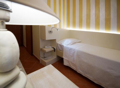 A bed or beds in a room at Albergo Morandi