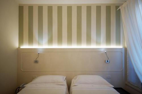 Ένα ή περισσότερα κρεβάτια σε δωμάτιο στο Albergo Morandi