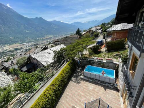 a person swimming in a swimming pool in a house at Relax in Valle D'Aosta da B&G in Aosta